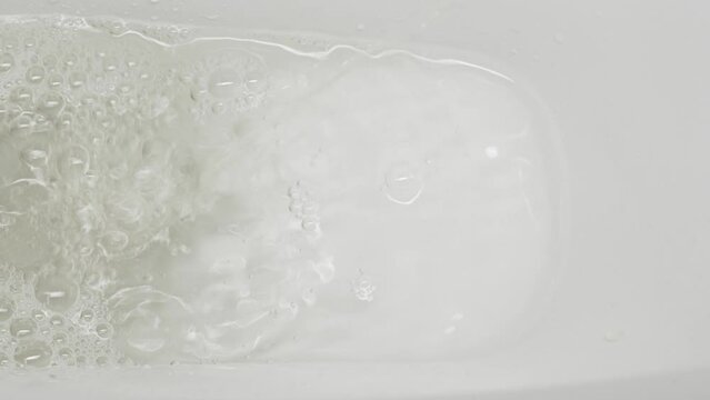 A stream of urine in a white toilet