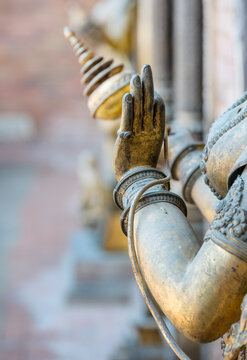 Bronze elegant hands of Buddha statue in Patan Durbar Square royal medieval palace and UNESCO World Heritage Site. Lalitpur, Nepal.