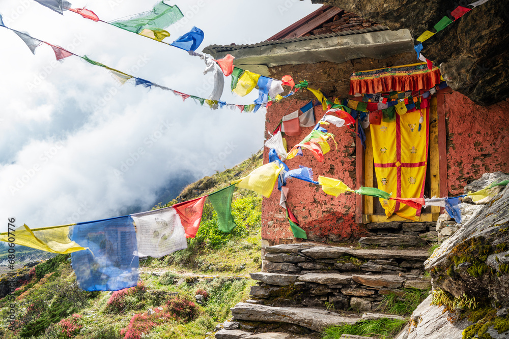 Wall mural small buddhist monastery decorated with multicolored tibetan prayer flags with mantras on kothe - th