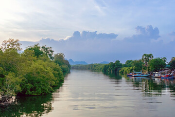 Fototapeta premium Beautiful scenic of fishing boat at pier with riverview in evening. Commercial fishing vessels docked at fish village. Wooden fishing craft boats were docked at local fishing pier with beautiful view.