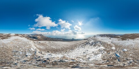 Winter snow mountain panorama. 360 seamless spherical aerial view above sea and snow covered frozen...
