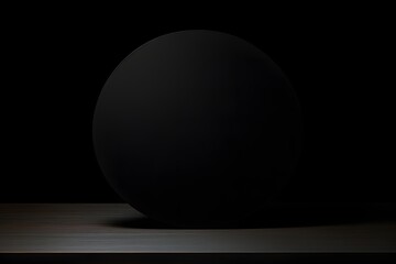 a black sphere sitting on top of a wooden table Generative AI