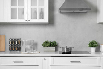 Potted artificial plants on white countertop in kitchen