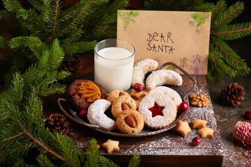 Christmas cookies and milk for Santa: linzer cookies with strawberry jam, crescents with sugar...