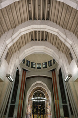 Art Deco interiors of Catholic minor basilica national shrine with massive dome and arch vaults, murals, altar and columns with Renaissance Revival style facade tourist pilgrim attraction