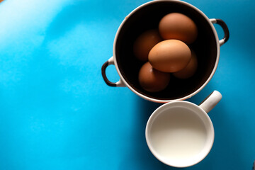 eggs in a bowl and a glass of milk