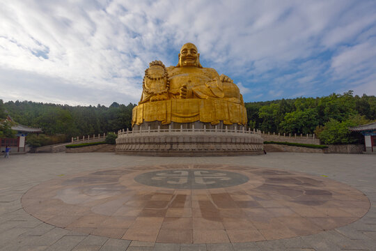 JINAN, CHINA, JUNE 26, 2023: Big golden statue of Maitreya Buddha in Qianfo Shan, also called mountain of the one thousand buddha, Jinan, Shandong Province, China