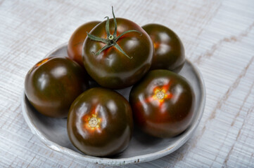 Fresh ripe sweet reddish brown and green kumato tomatoes