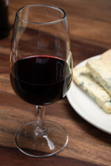 Red porto and cheese pairing, blue matured stilton English cheese served as dessert with walnuts and glass ruby porto wine