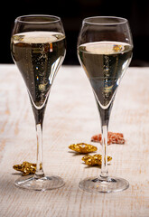 Glasses of bubble wine champagne, cremant, cava or prosecco and christmas stars for decoration