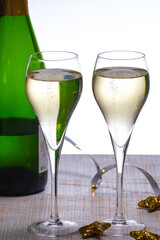Glasses of bubble wine champagne, cremant, cava or prosecco and christmas stars for decoration