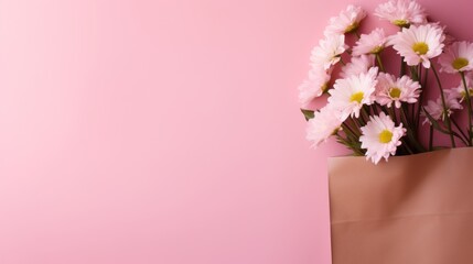 Paper bag on a pink background with flowers, minimalist backgrounds
