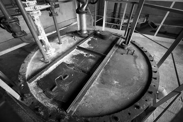 The cover of the tank with chlorine in the premises of the enterprise for the preparation of urban drinking water supply, black and white image.