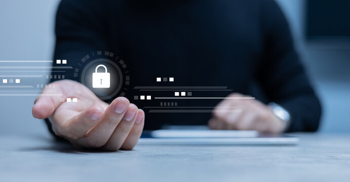 close up young man hand show virtual reality interface locked icon for protection data in office operation room for cyber security and digital authentication concept