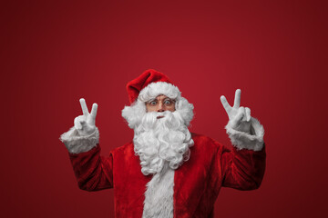 Santa Claus with peace signs, spreading joy and love on Christmas