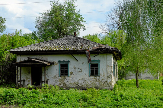 The house in the image is in disrepair, with peeling paint and a sagging roof.