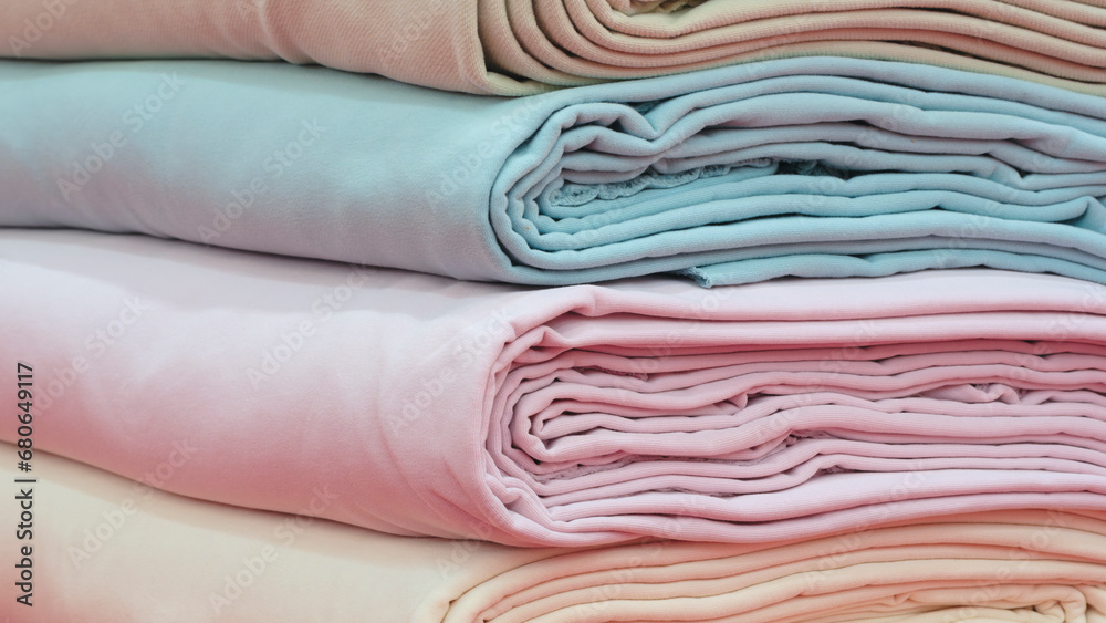 Poster Shelf with a wide selection of colorful fabrics. Colorful ribbons on the shelf in the store. Textile industry
