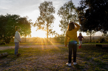Children playing in nature at sunset