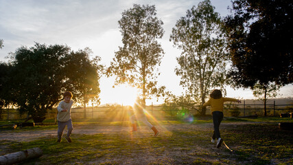 Children running outdoors at sunrise