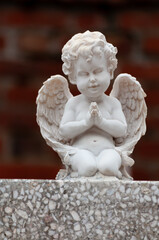 Close-up of an angel on a tombstone in a cemetery