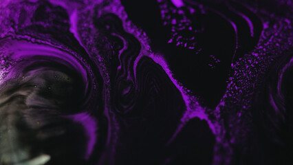 Paint flow. Ink blend wave. Defocused neon purple black color acrylic fluid mix motion foam texture...