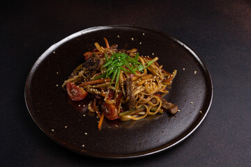 Asian cuisine. Noodles with meat. Close-up of the dish