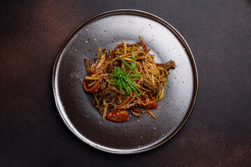Asian cuisine. Noodles with meat. Close-up of the dish