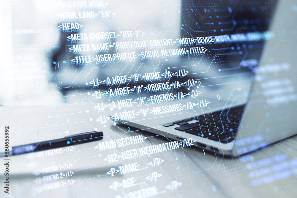Poster close up of laptop on desk with pen, notepad and creative digital programming language on blurry bac