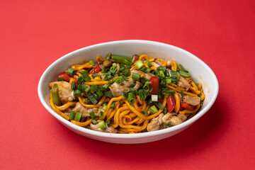 Asian cuisine. Noodles with chicken. Close up