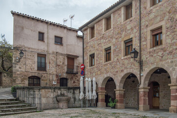 Stone buildings with semicircular arches and stairs in one of the corners of the Plaza de la Carcel in Sigüenza, province of Guadalajara. Spain
