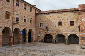 Stone buildings with semicircular arches in one of the corners of the Plaza de la Carcel in Sig&uuml;enza, province of Guadalajara. Spain