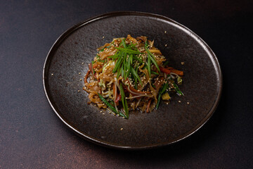 Asian cuisine. Noodles with vegetables. Close-up
