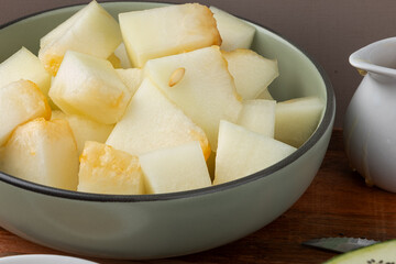 Snap melon cubes on plate. Selective focus.