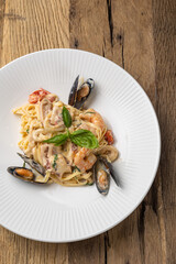Italian cuisine. Pasta with seafood, mussels and shrimps. Close up