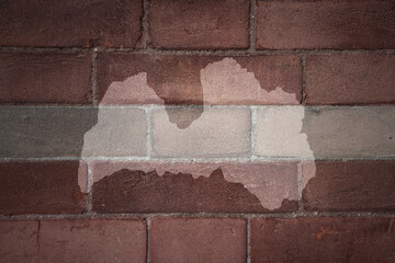 Obraz premium map and flag of latvia on a old brick wall