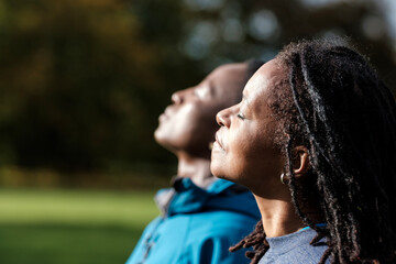 Portrait of two mature black women enjoying sun in an autumn day.