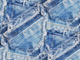 Blue jeans destroyed and torn with a seamless patchwork pattern.
Denim fabric for youth best for background and fashion wallpaper. Grunge or hippie style.