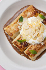 Ukrainian cuisine. pancakes with sour cream and almond flakes . Close-up