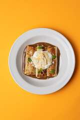 Ukrainian cuisine. pancakes with sour cream and almond flakes . Close-up