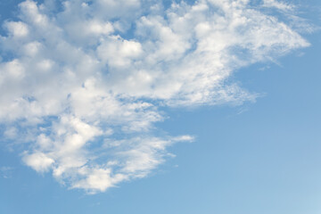 White clouds and light blue sky background.