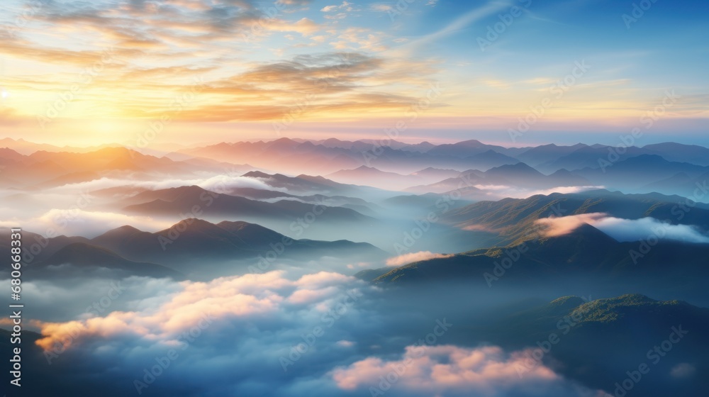 Wall mural a view of a sunset over a mountain range with clouds and mountains in the foreground and the sun in 