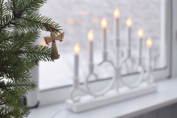 Adventsljusstake - traditional Swedish Christmas window decoration.blurred background