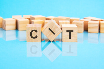 CIT on wooden cubes on blue background