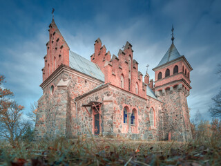 view from low point to facade of old cathedral under dramatic sky in Ukraine