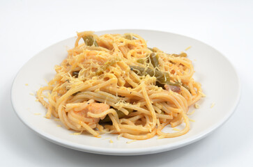 spaghetti with asparagus and meat stewed on a white plate