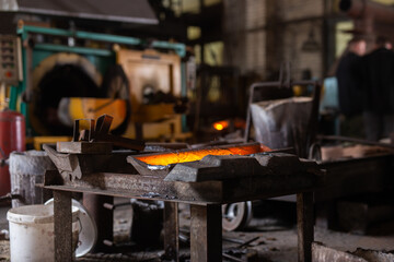 Mold with molten metal in the foundry workshop of metallurgical plant
