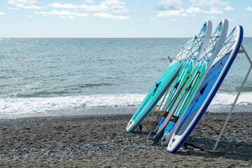 surfboards on the seashore against the blue sky