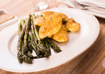 Dietary meal rich in protein. Stir fried chicken breast and green asparagus