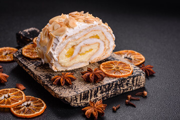 A piece of delicious sweet meringue roll with mascarpone cheese, berries and almonds