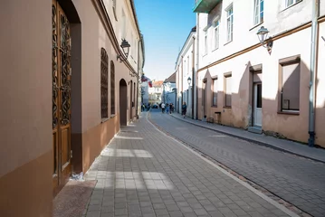 Fototapete Rund street in the center of the old town of Vilnius, Lithuania © Sheviakova